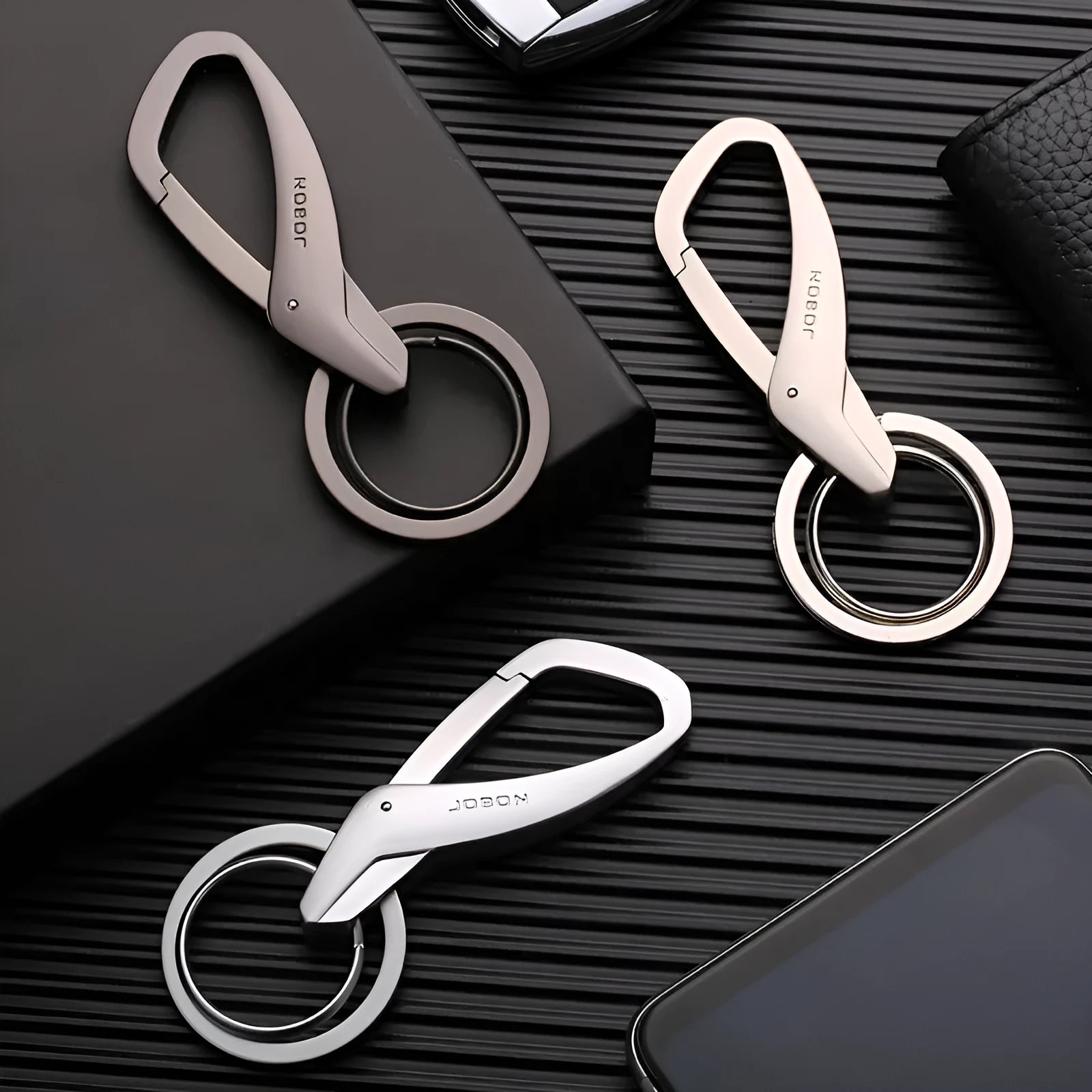 Simple double ring metal keychain in zinc alloy, shown in black, chrome, and nickel colour options.