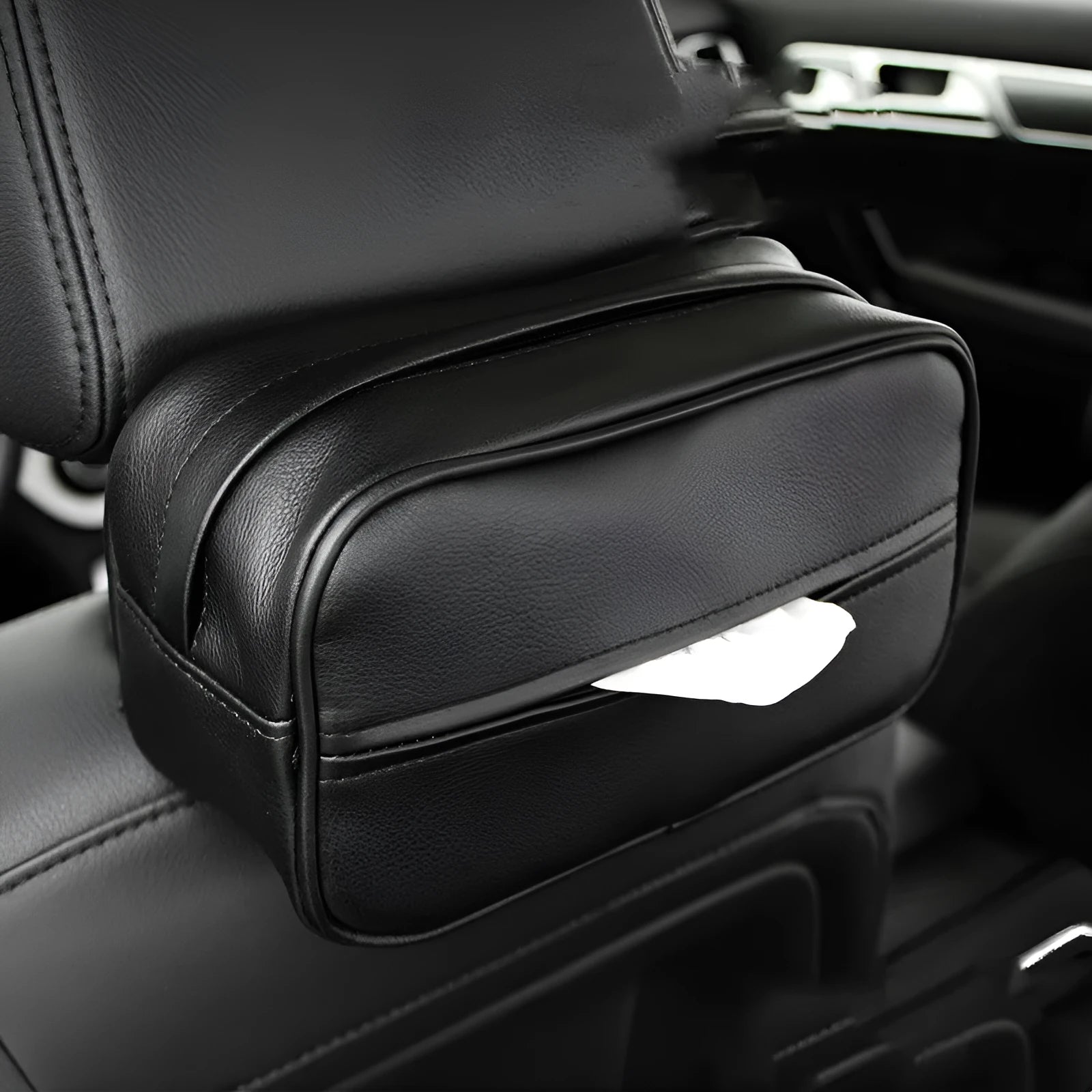 Black PU leather car storage box with hanging straps shown on a car headrest.