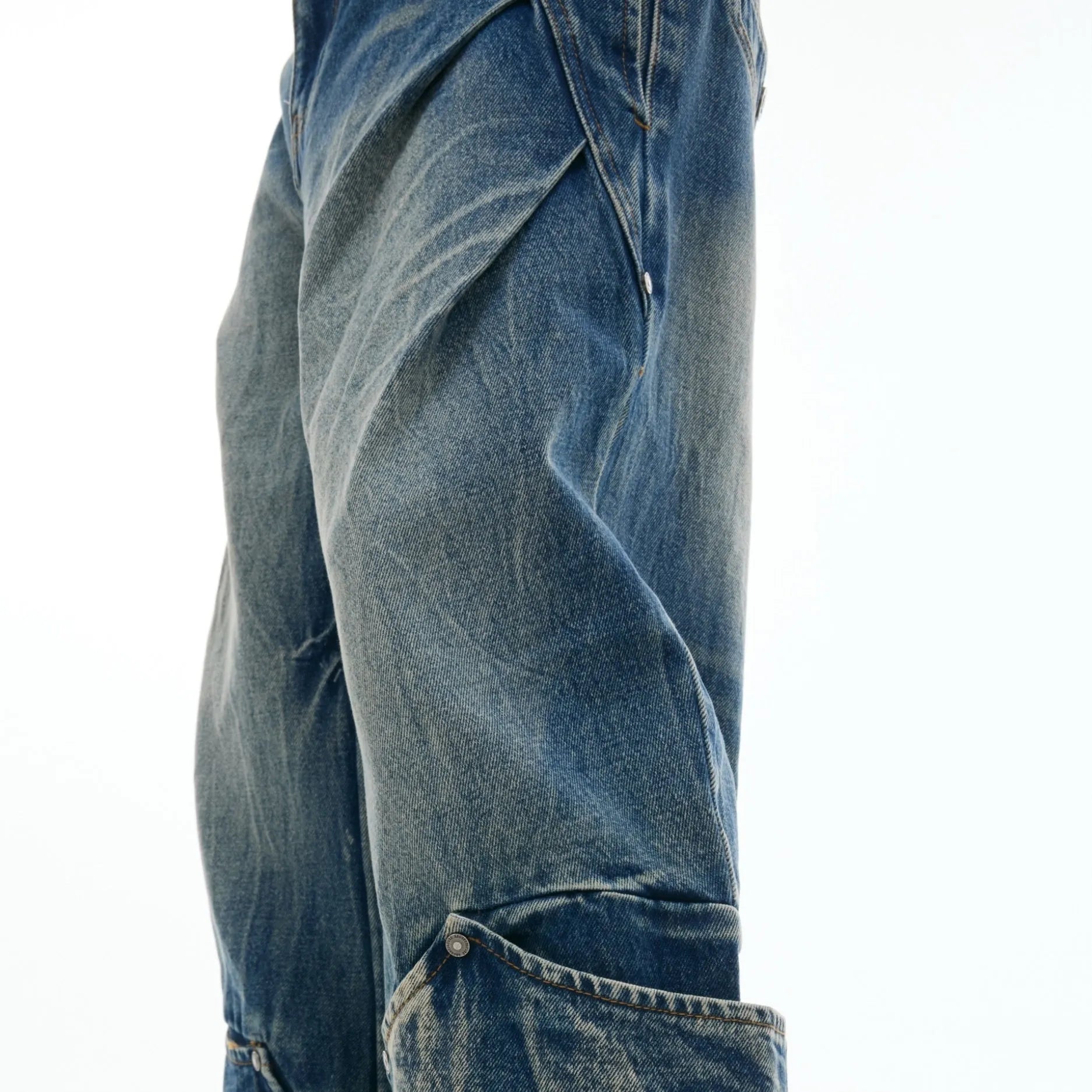 Men's verdant blue retro washed loose fit jeans with burst pattern and curved knife detail.