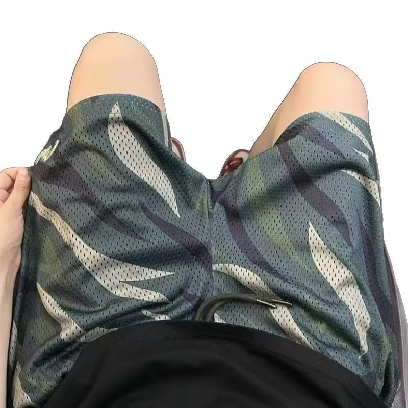 Men's straight-leg camouflage shorts in a cotton blend fabric, shown in a casual setting.