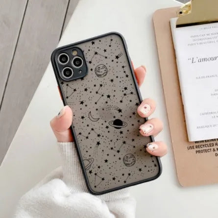 Star universe patterned black iPhone case on a mobile phone, showing raised edges around the screen and camera.