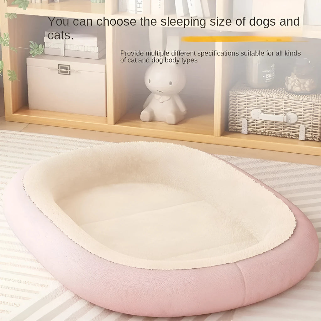 A grey thickened pet kennel with a fleece cover for a small dog resting inside on a wooden floor.