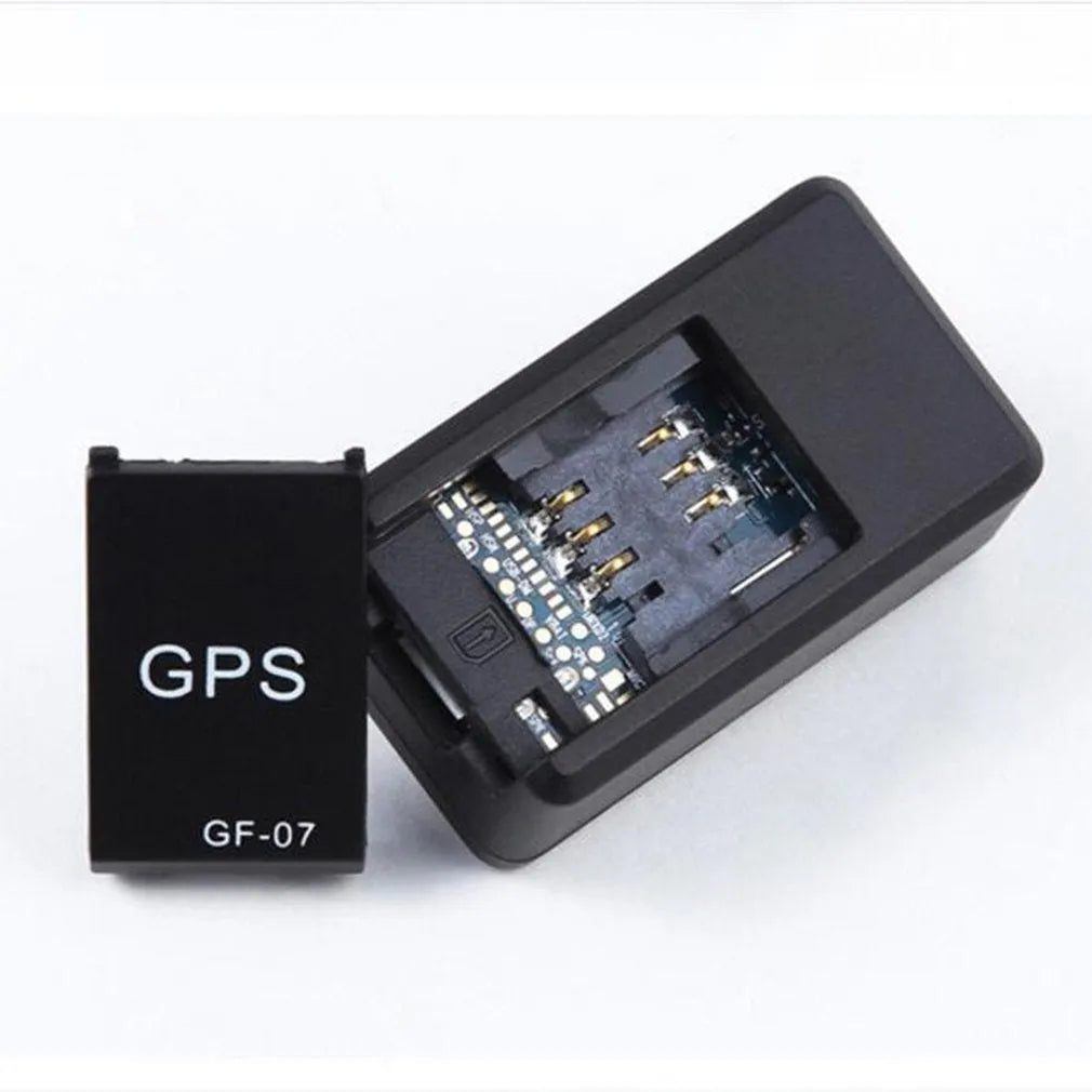 Small black magnetic GPS car tracker device with USB charging cable.