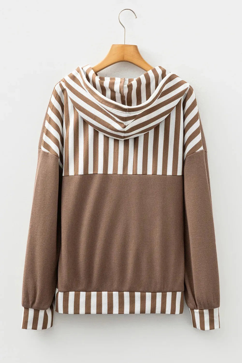 Straw yellow hoodie with waffle texture fabric and striped patchwork panels, featuring a drawstring hood and button neck.