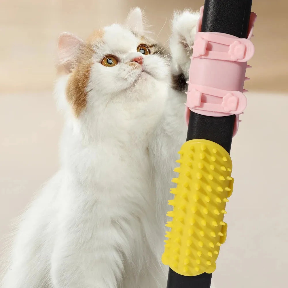 Silicone cat grooming comb with adjustable strap mounted on a table leg, shown in yellow.