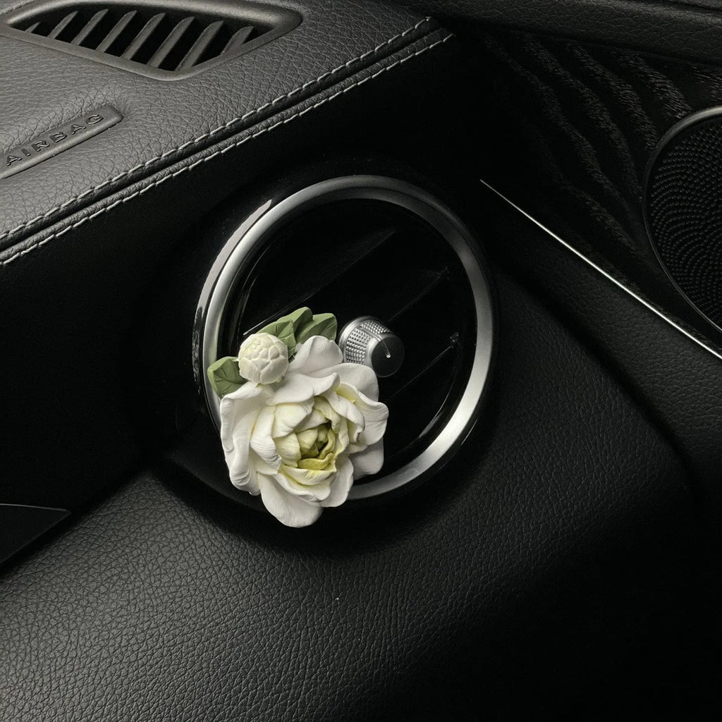 Jasmine car perfume solid air outlet freshener in off white or fresh green colour on car vent