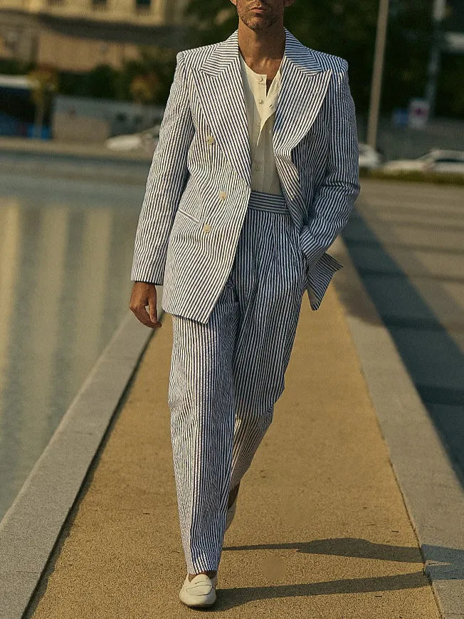 Blue and white striped polyester blazer and trousers suit set on a hanger.