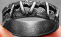 Dark stainless steel double ring with punk stitching pattern, shown in UK size range 7 to 15.