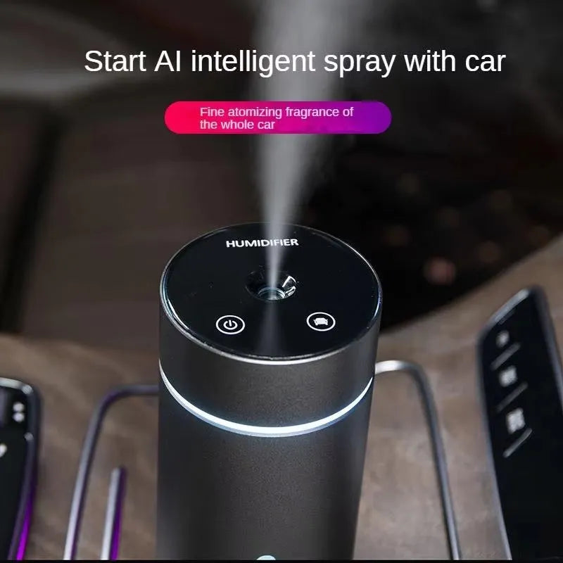 Compact black aluminium car humidifier and essential oil diffuser with USB cable on a desk.