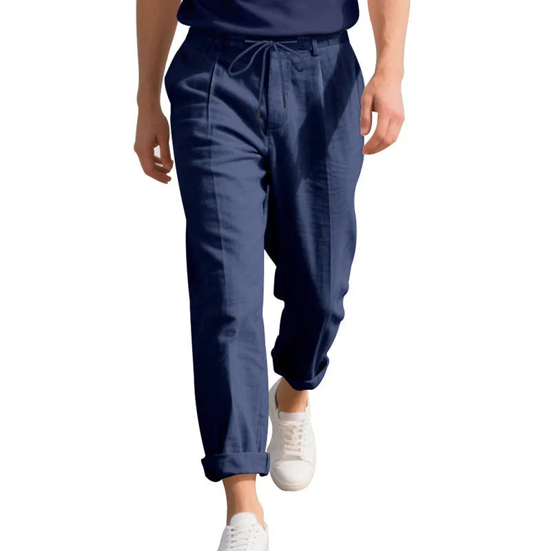 Men's light khaki linen casual trousers with a drawstring waist and straight leg fit.