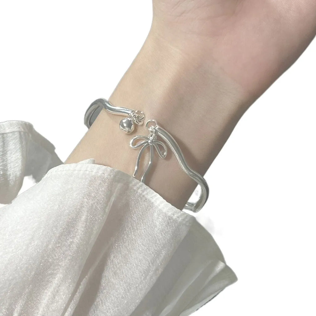 Silver adjustable bracelet with bow decoration and bell opening clasp on zinc alloy chain