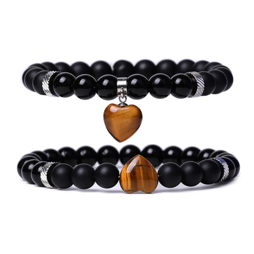 Two matching natural stone heart bracelets with geometric shape and polished finish.
