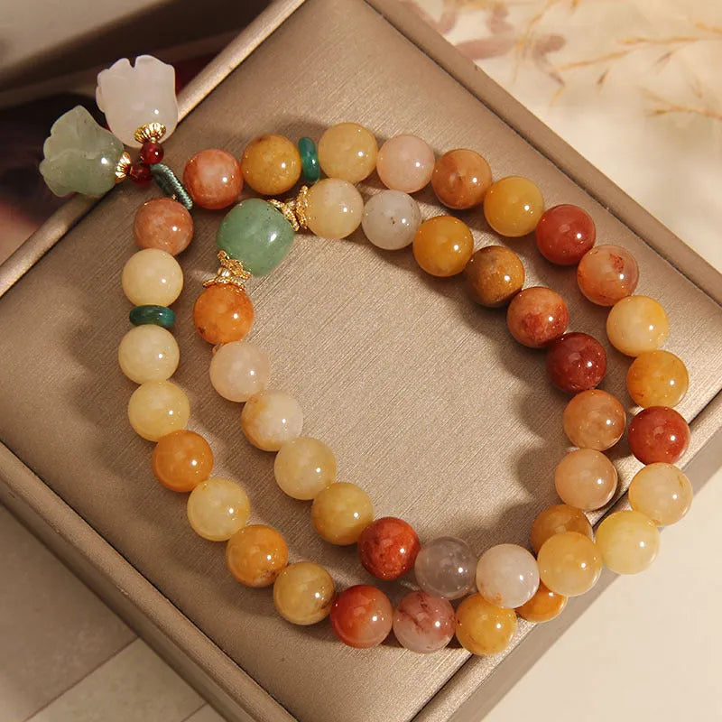 Dark green natural jinsi jade multi-layer bracelet with orchid pendant and adjustable sliding knot clasp.