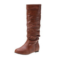 Women's flat heel slip-on ankle boot in artificial PU, shown in a solid colour with a round toe and high-top design.
