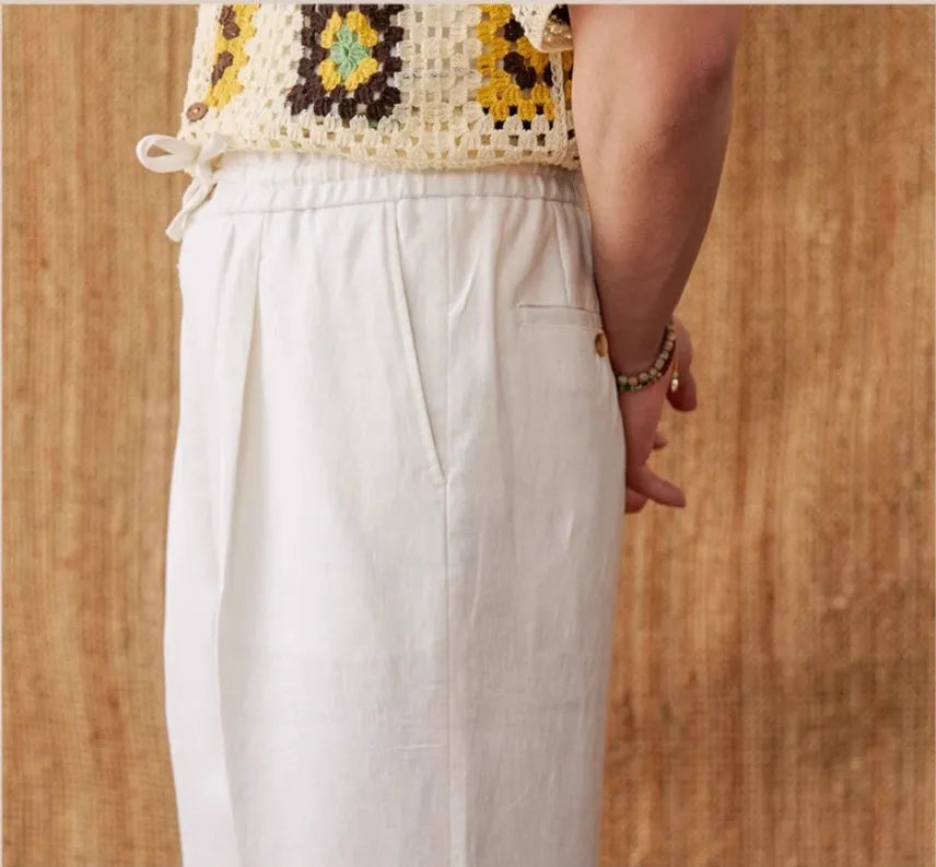 Linen high-waisted trousers with elasticated waist and lace trim in a straight-leg, loose fit.