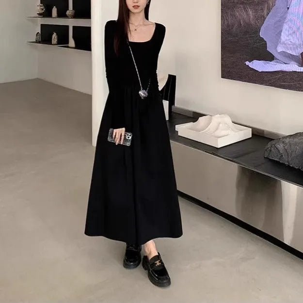 Women's black knitted A-line dress with square collar and long sleeves on hanger