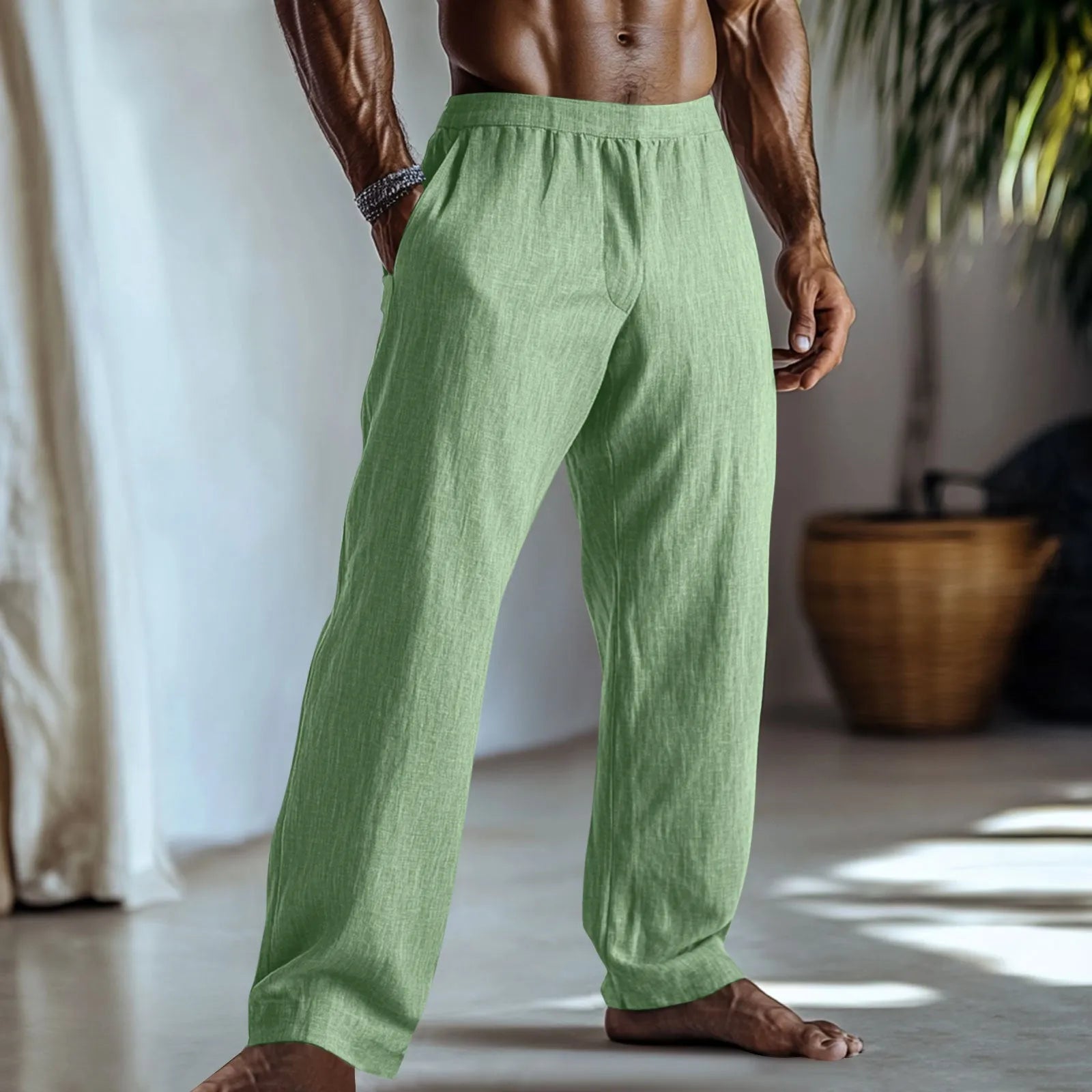 Straight leg casual trousers in cotton and linen fabric in a light green colour, shown with side pockets.