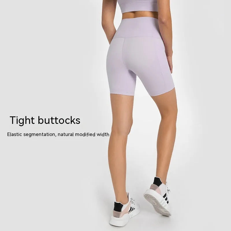 Women's tight-fitting sport shorts in a solid colour, shown on a model for running or gym use.