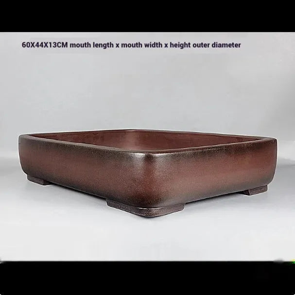 Handmade antique rectangular purple clay flower pot showing traditional ceramic texture