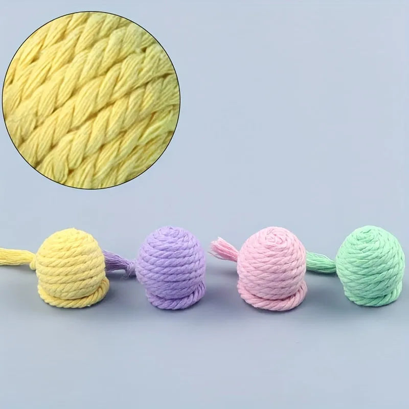 Colourful cat toy ball with attached rope and internal bell for interactive feline play