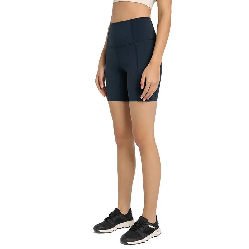 Women's tight-fitting sport shorts in a solid colour, shown on a model for running or gym use.