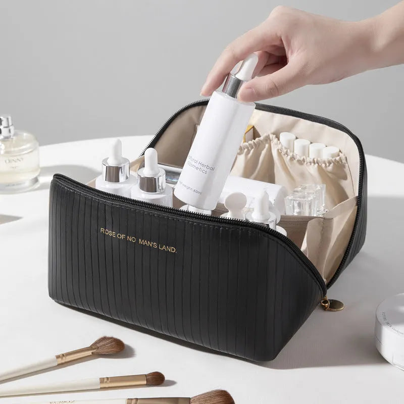 Vertical striped cubic makeup bag in beige with 22.5cm dimensions showing open interior