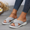 Women's black wedge slippers with peep-toe design and thick rubber sole