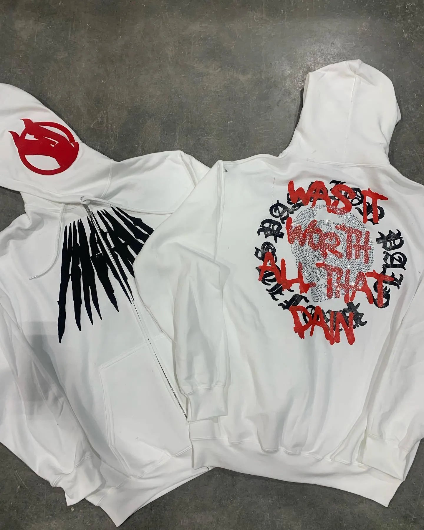 Black hooded sweatshirt with printed skull pattern and rhinestone detailing in loose cardigan style