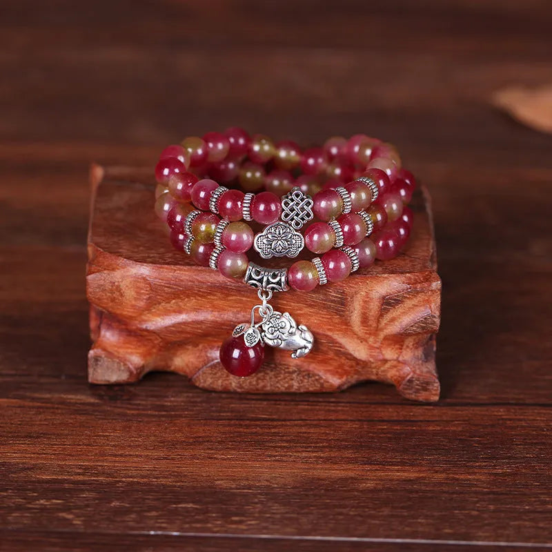 Handmade geometric bracelet made from natural watermelon crystal beads with Chinese knot closure.