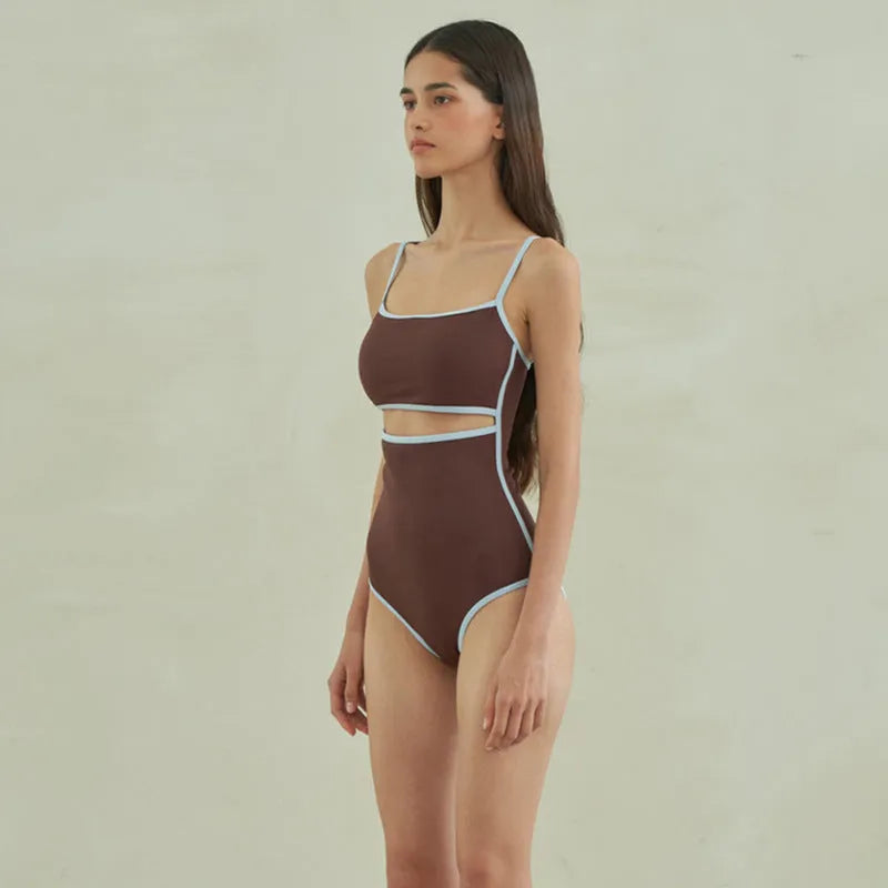Brown women's one-piece swimsuit with triangle neckline design on mannequin