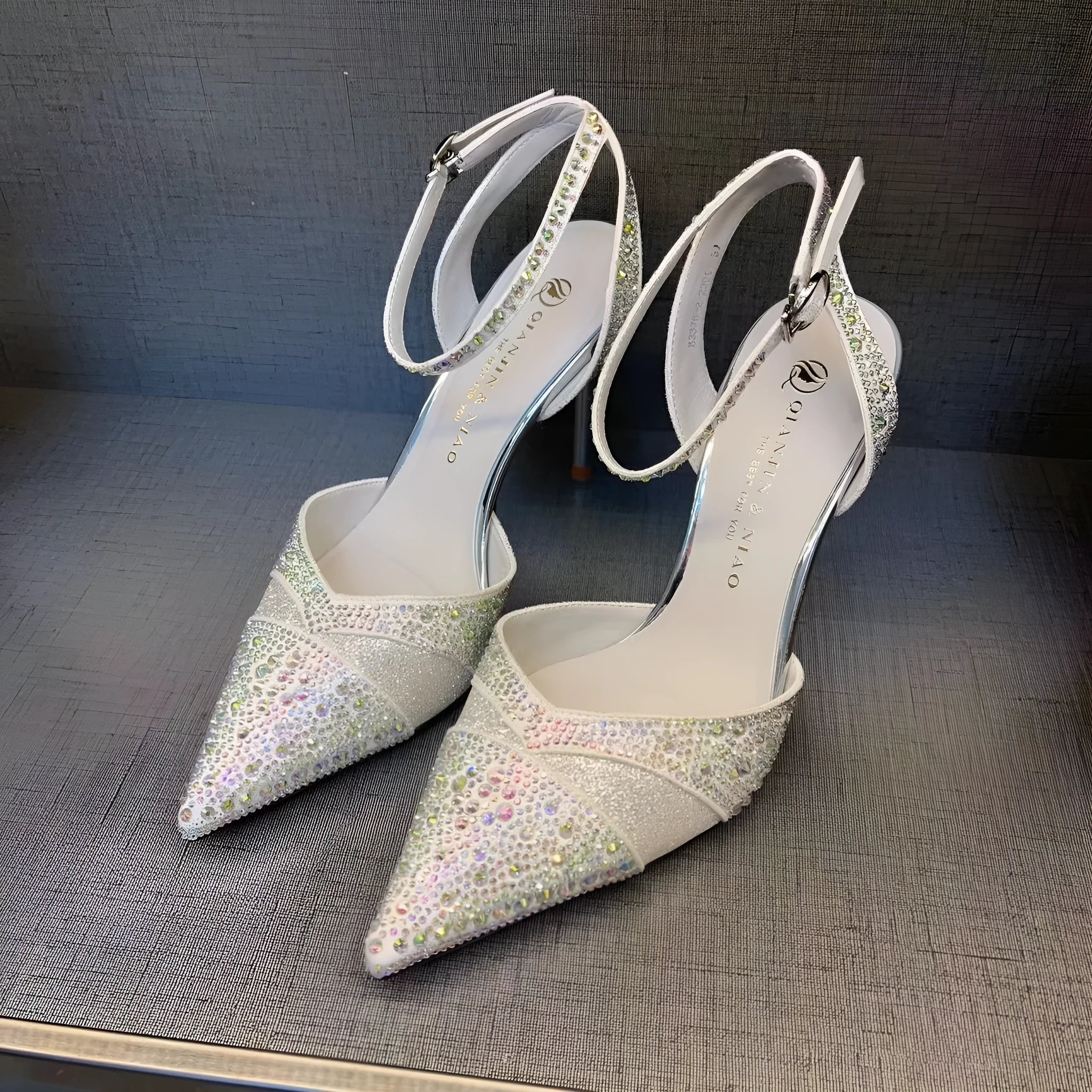 Women's black hollow high heels with stiletto heel, pointed toe, and red sole