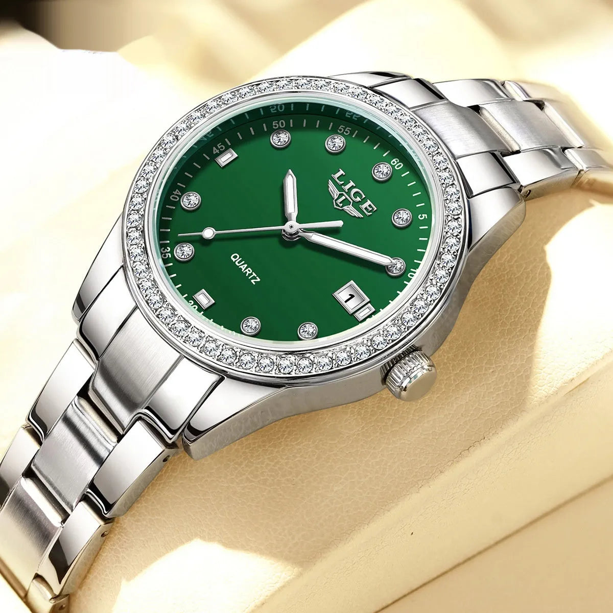 Silver stainless steel women's quartz watch with diamond bezel and luminous hands on a round 34mm dial.