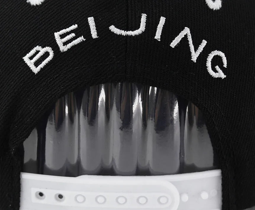 Cotton baseball cap with embroidered letters in black colour showing dome crown shape