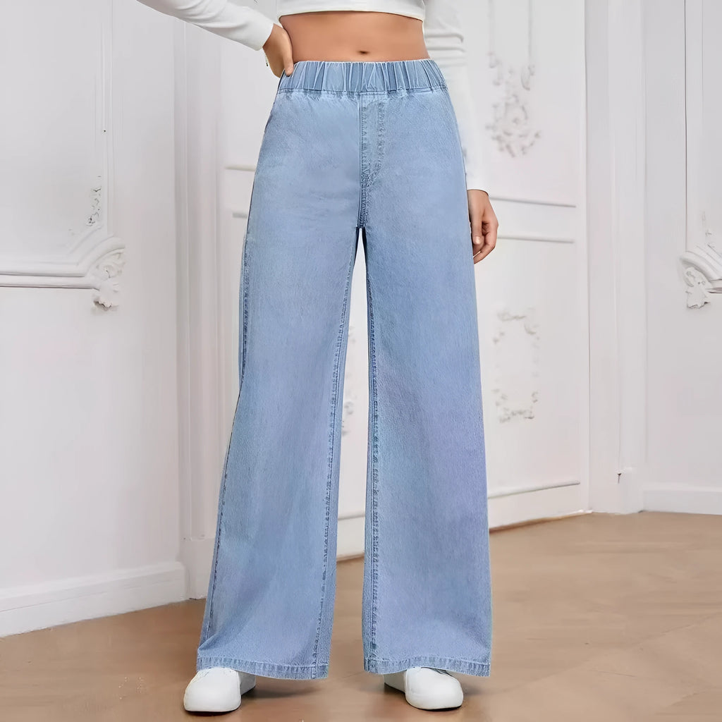 Light blue washed wide-leg denim trousers on a hanger, showing mid-rise waist and straight leg cut.