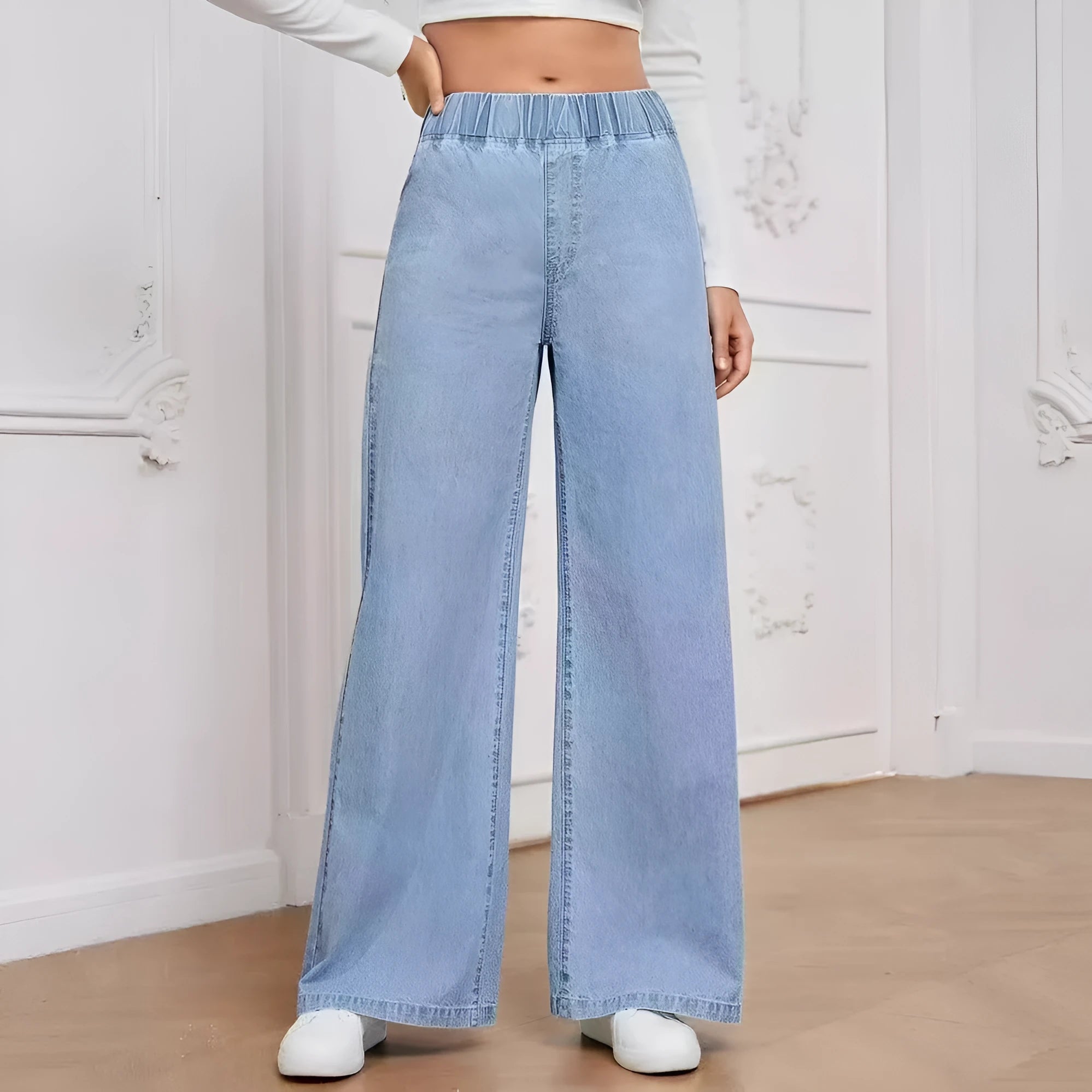Light blue washed wide-leg denim trousers on a hanger, showing mid-rise waist and straight leg cut.