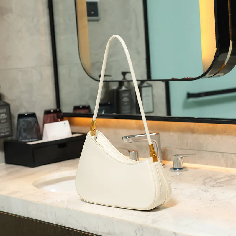 Retro oval women's underarm shoulder bag in PU leather with single strap and zippered interior