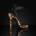 Leopard print women's gladiator sandals with pointed toe and lace-up front on a rubber sole.