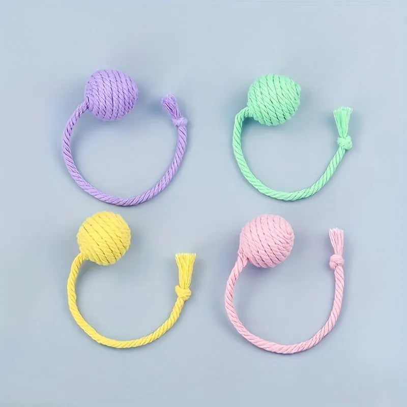 Colourful cat toy ball with attached rope and internal bell for interactive feline play
