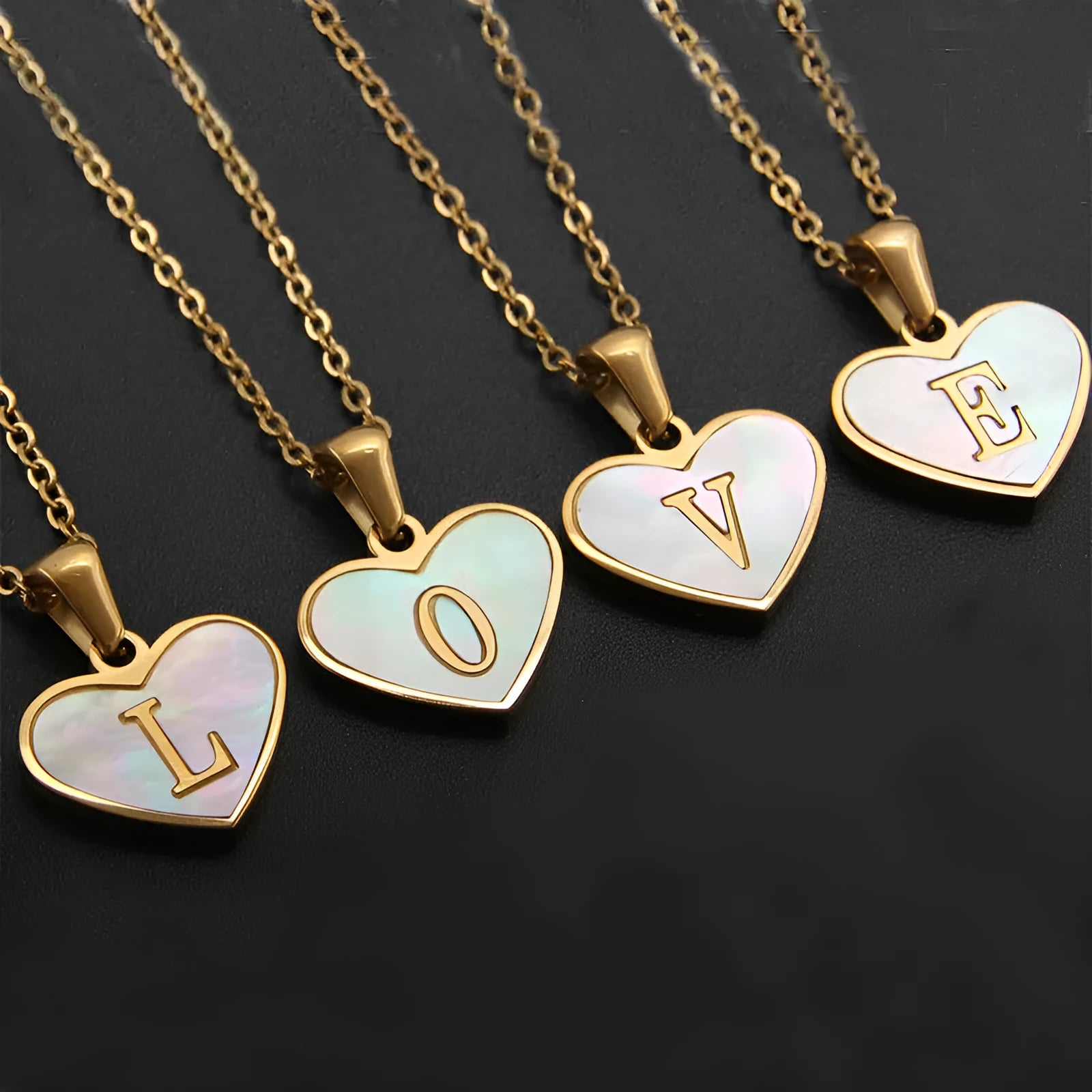 Heart-shaped letter necklace with white shell detail on gold-plated stainless steel chain