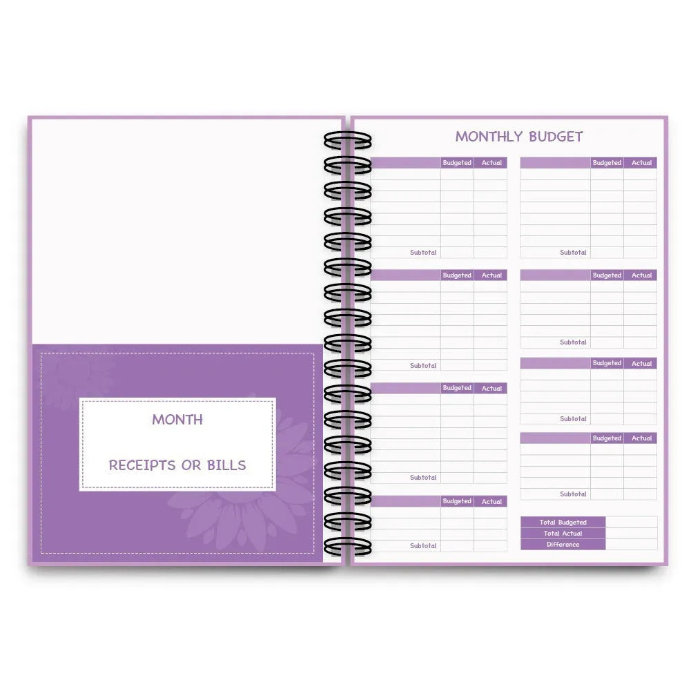 Purple coil-bound financial planning notebook with pen and stickers on a desk.