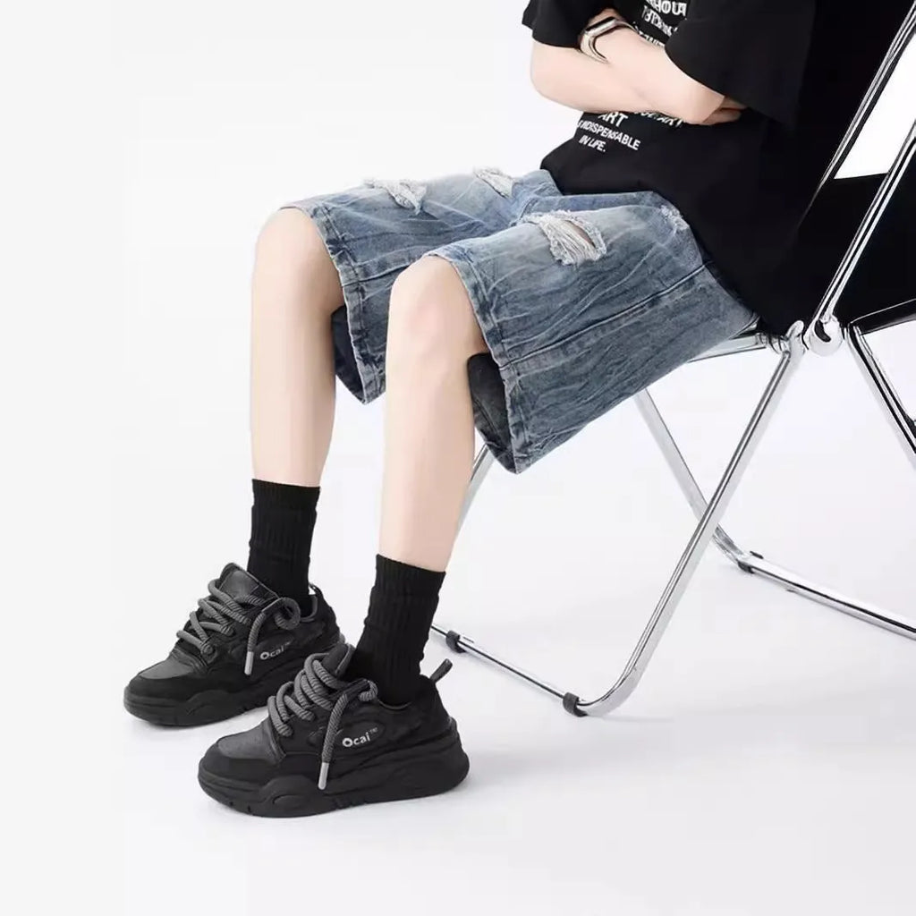Black and Blue ripped denim shorts with a washed vintage finish and loose, retro fit.
