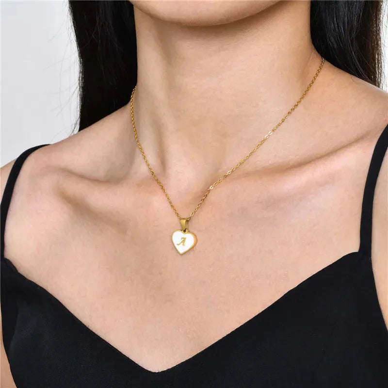 Heart-shaped letter necklace with white shell detail on gold-plated stainless steel chain
