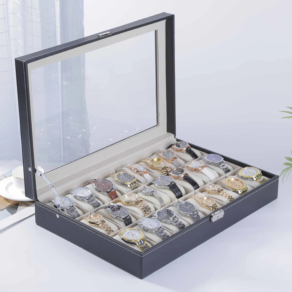 Grey leather watch storage box with transparent lid showing watch cushions inside.