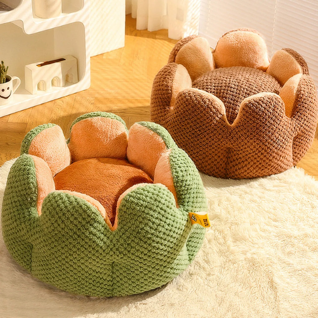 Green cactus petal shaped enclosed plush bed for a cat or small dog on a hardwood floor.