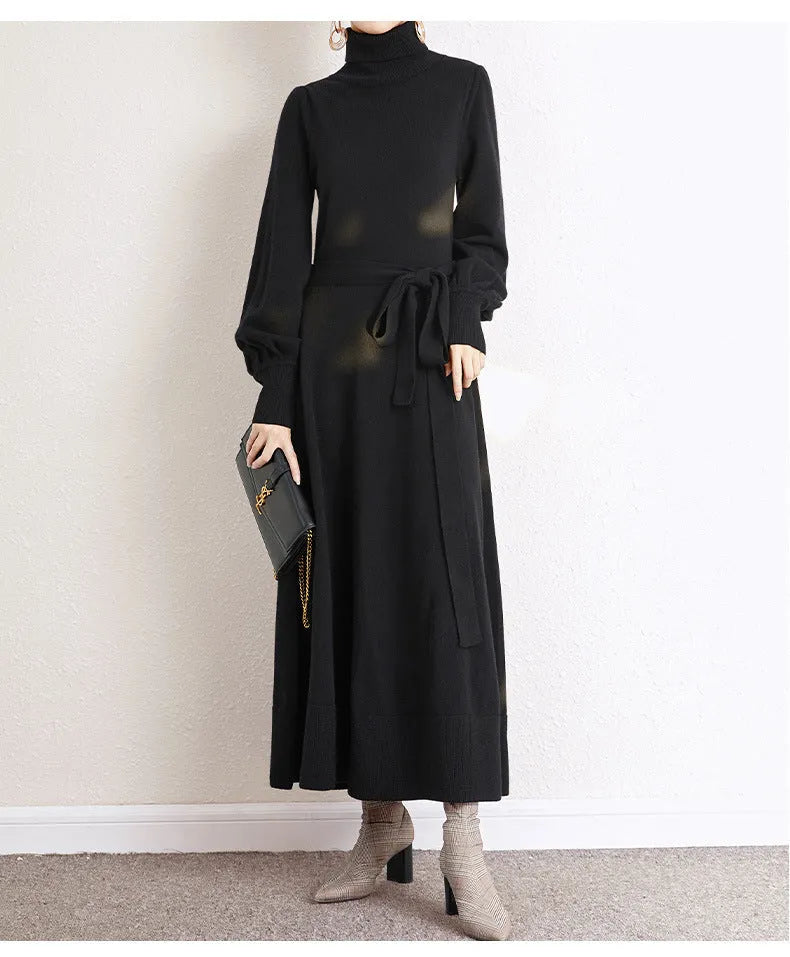 A rose red knitted turtleneck dress with long sleeves, an elastic waist, and a loose mid-length skirt.
