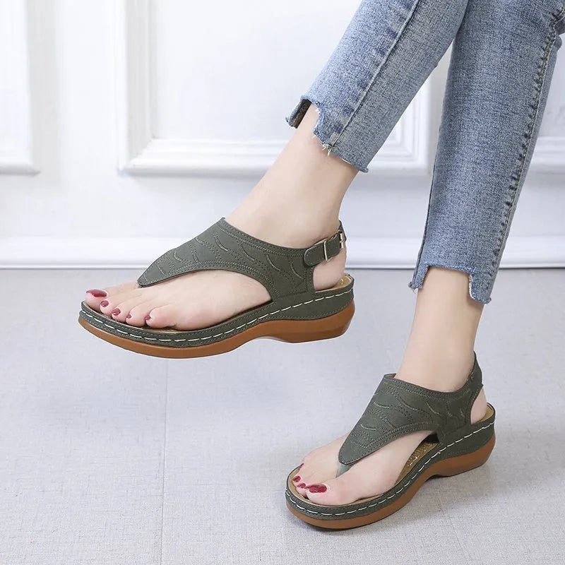 Women's casual wedge heel flip flop sandals with an adjustable buckle strap in solid colours.