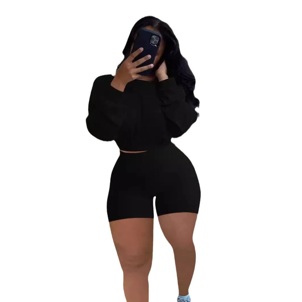 Women's off-the-shoulder long sleeve top with sunken stripe detail and matching solid colour shorts two-piece set.