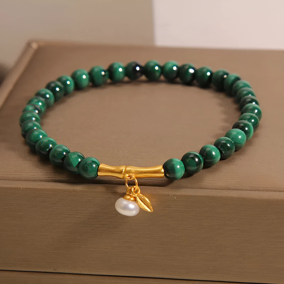 Close-up of a women's adjustable crystal bracelet with a white Lucky Bamboo design on wrist.