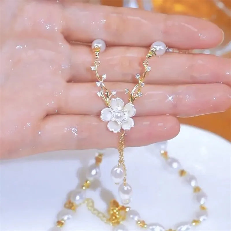 Alloy fashion necklace with pearl flower design and rose floral elements on pearl chain