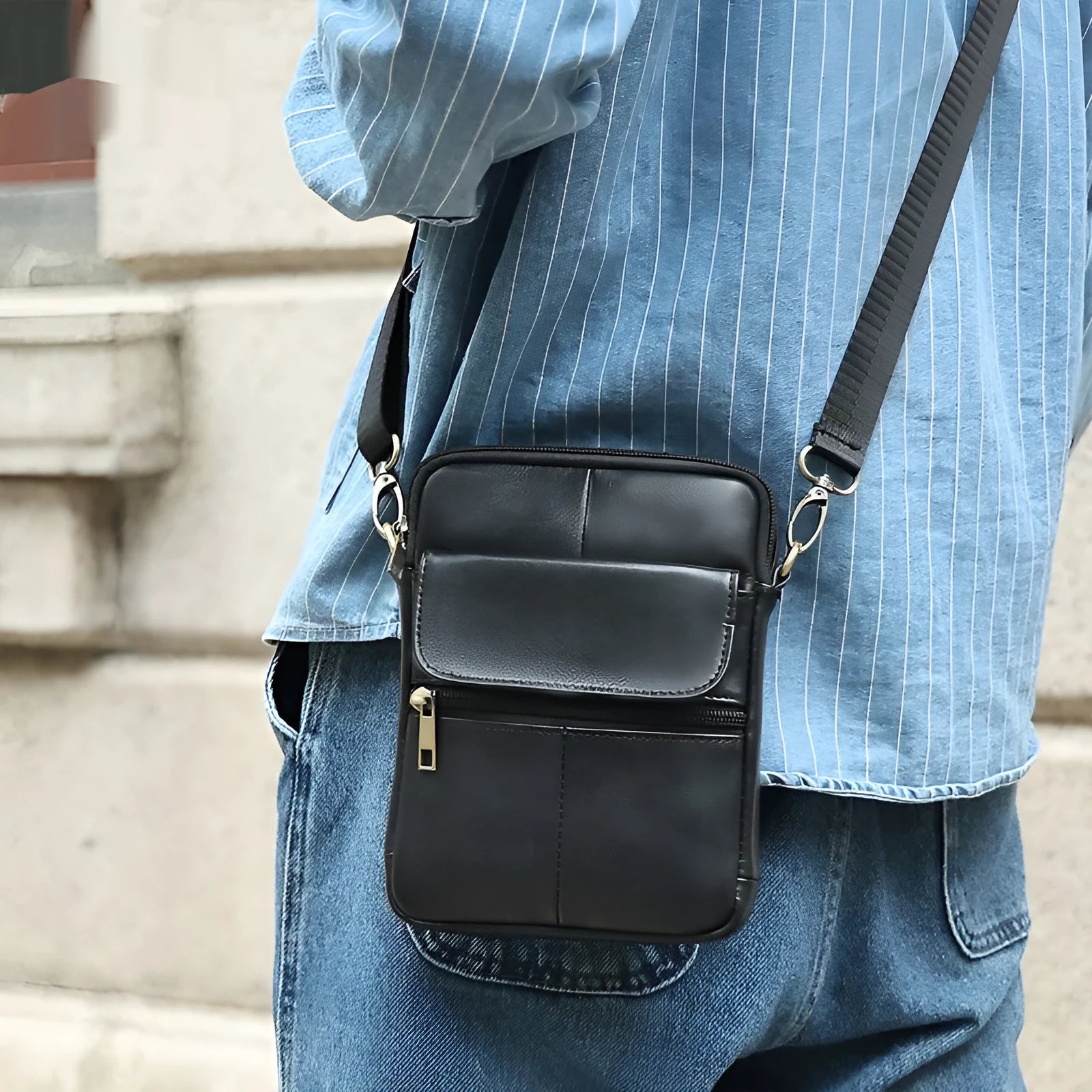 Men's brown leather crossbody shoulder bag showing sewing line details and strap